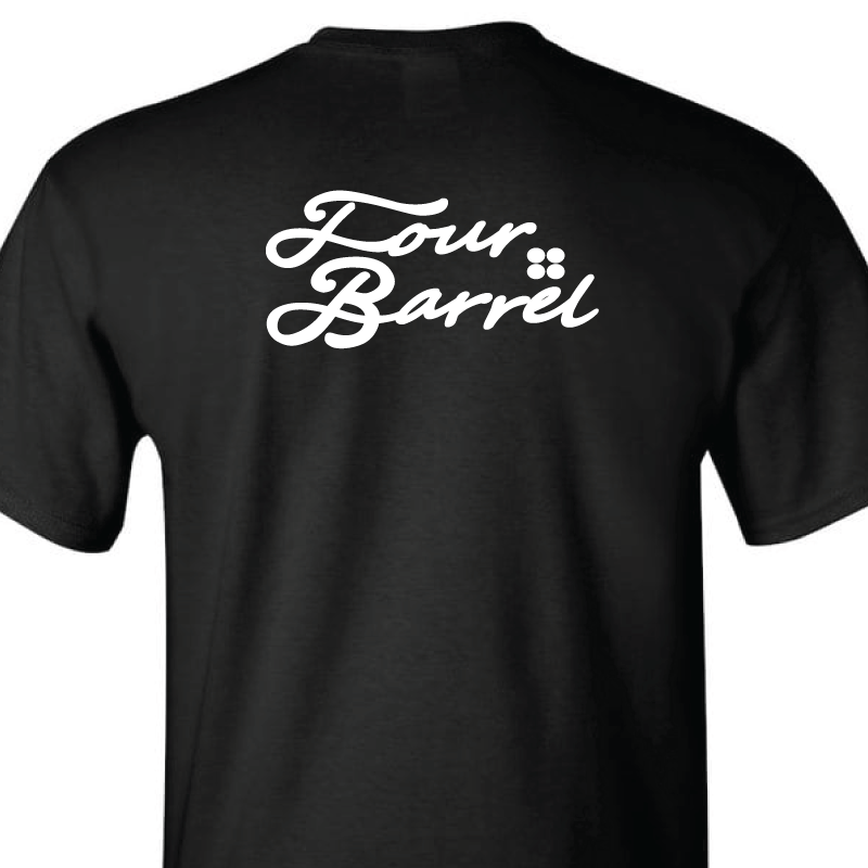 Close up view of black tshirt with small white script on back of shirt that states Four Barrel Apparel with the logo of 4 circles